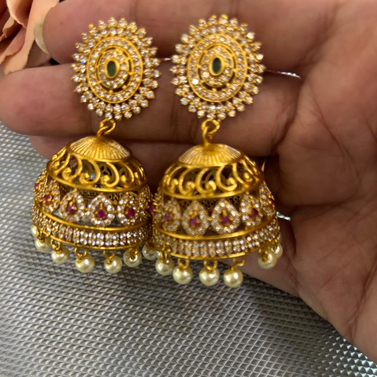 Close up of American diamond jhumka earrings