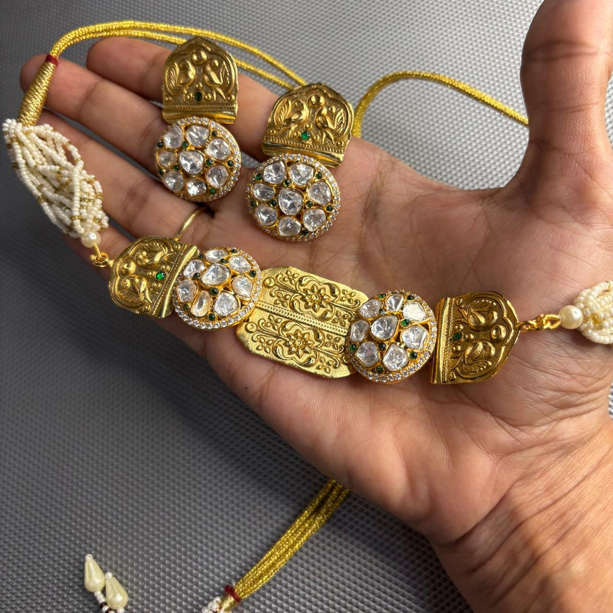 Handheld Aaradhya gold polki moissanite pearl choker necklace set with matching earrings