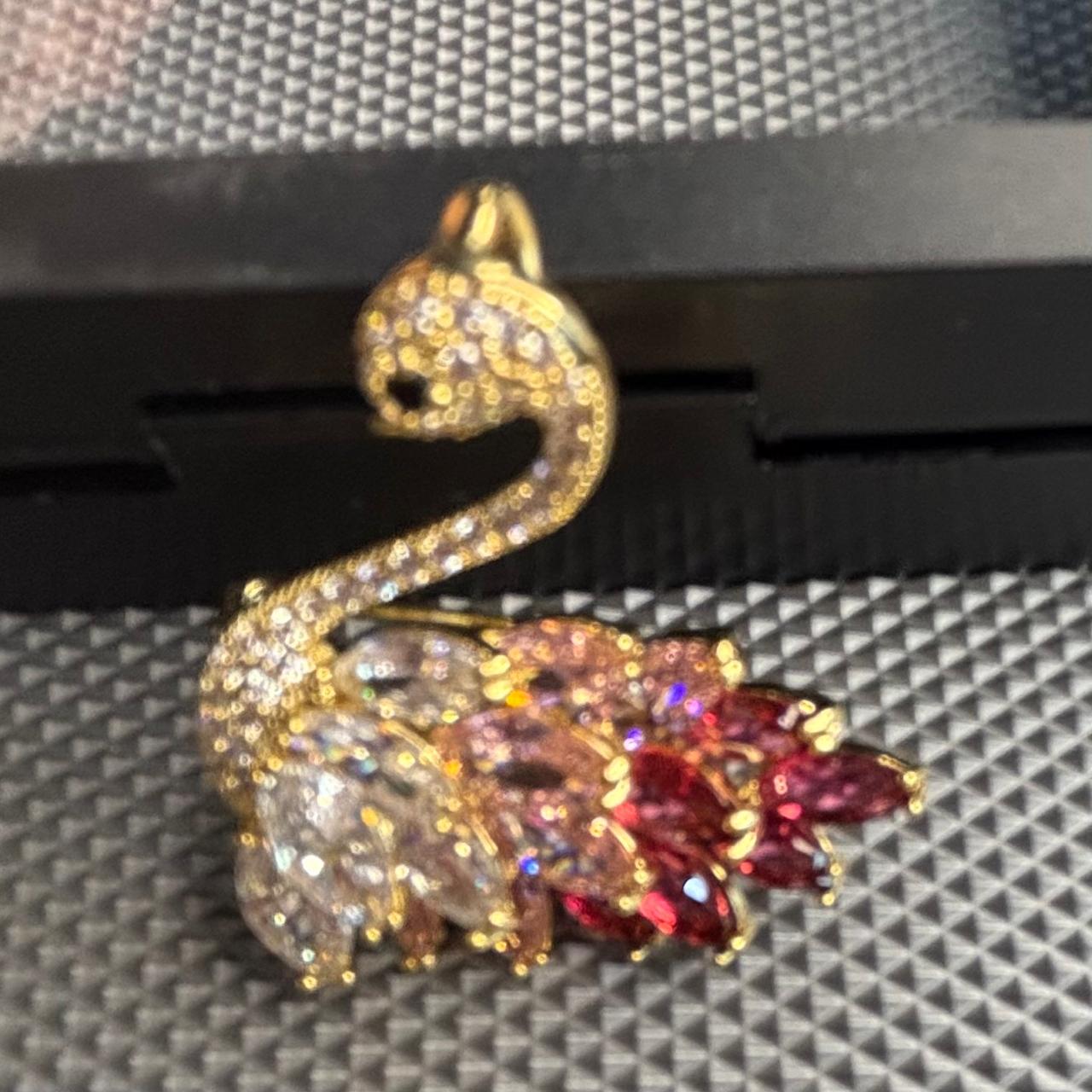 Crystal swan brooch pin featuring layered pink , red and clear feather stones and CZ diamonds on gold tone