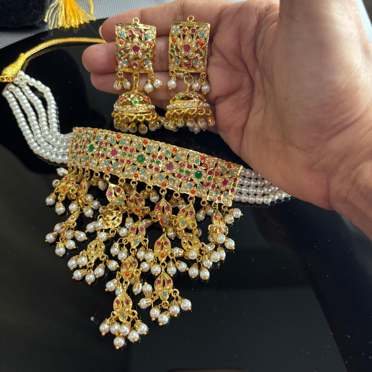 jadau necklace set with pearl drops and jhaalar with matching jhumka earrings on hand