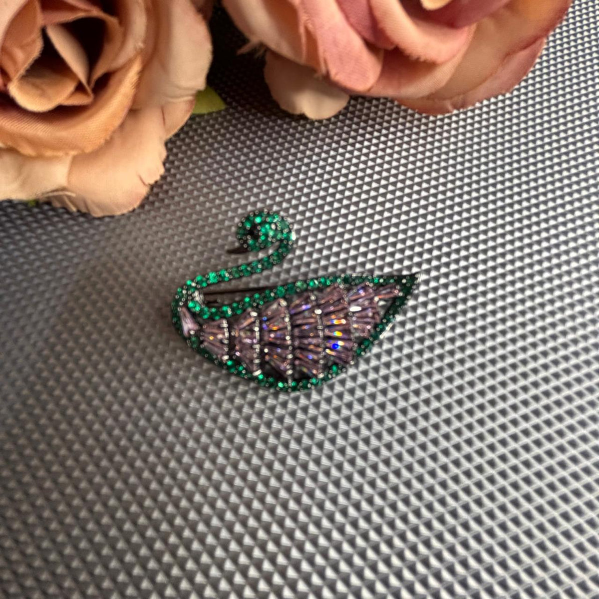 Lavender crystal swan brooch with green stone detailing