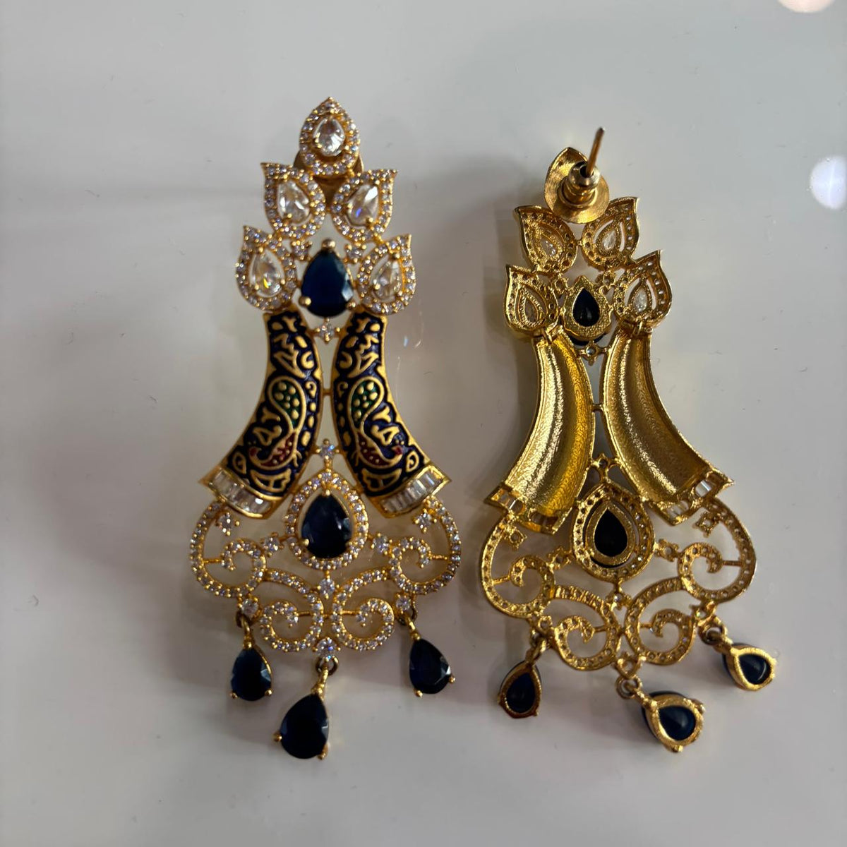 Backside of a Pair of AD chandelier cocktail earrings with blue stones