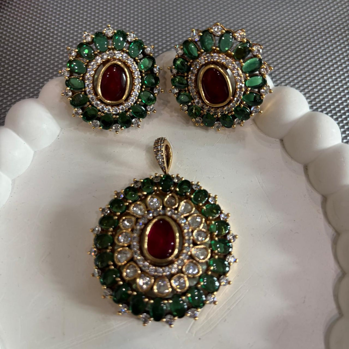 Gold tone pendant set with polki kundan , ruby red and emerald green stones