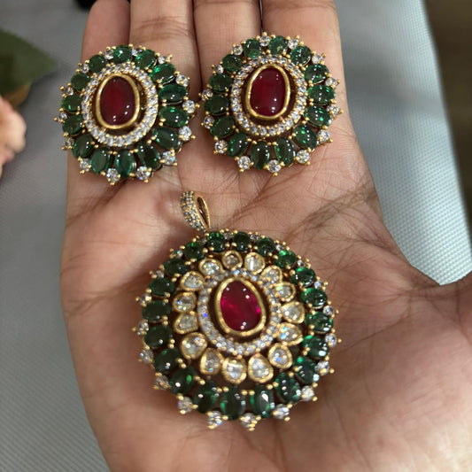 Handheld Gold tone pendant set with polki kundan , ruby red and emerald green stones