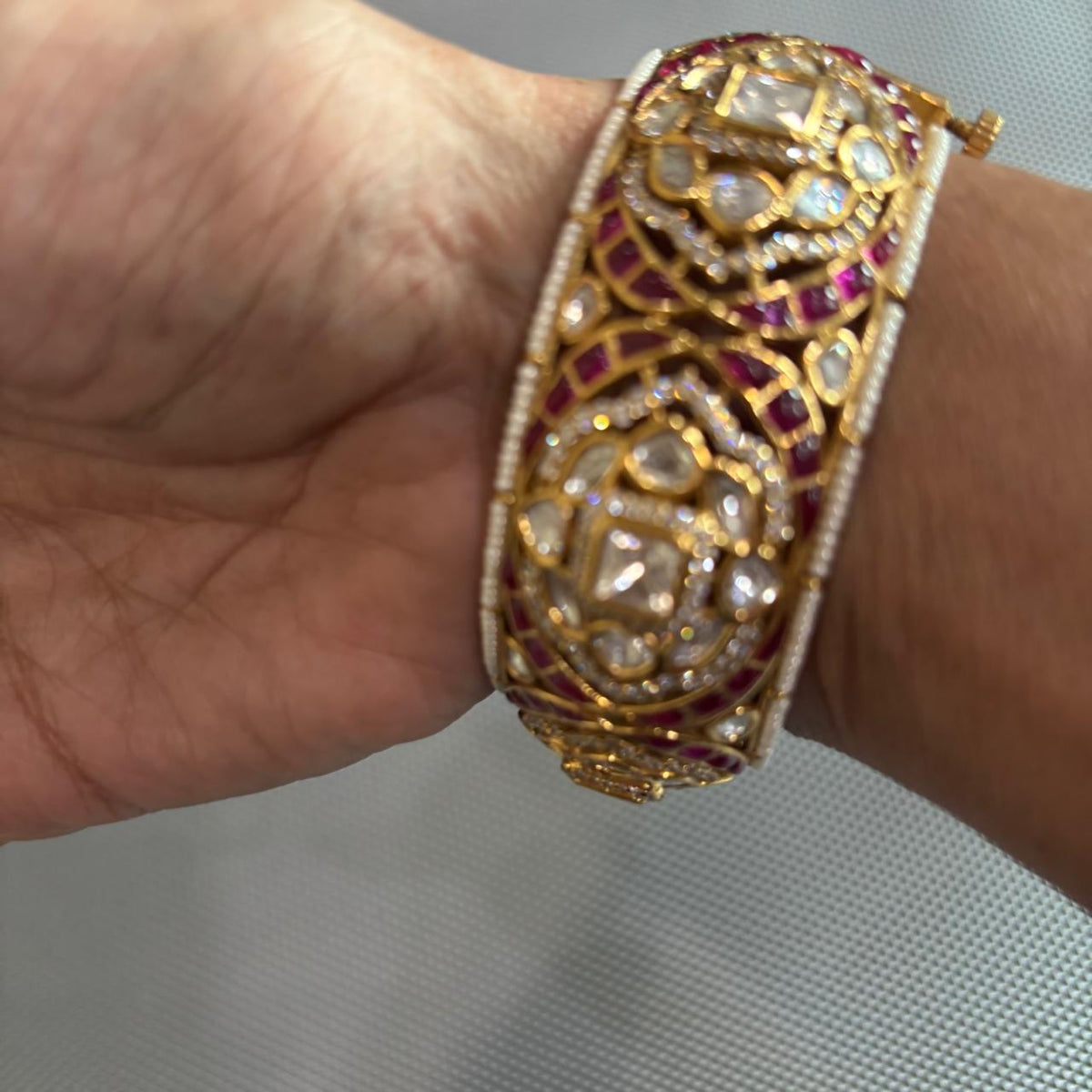 Openable Gold tone moissanite Polki kada with ruby detailing , pearls and uncut diamonds on hand