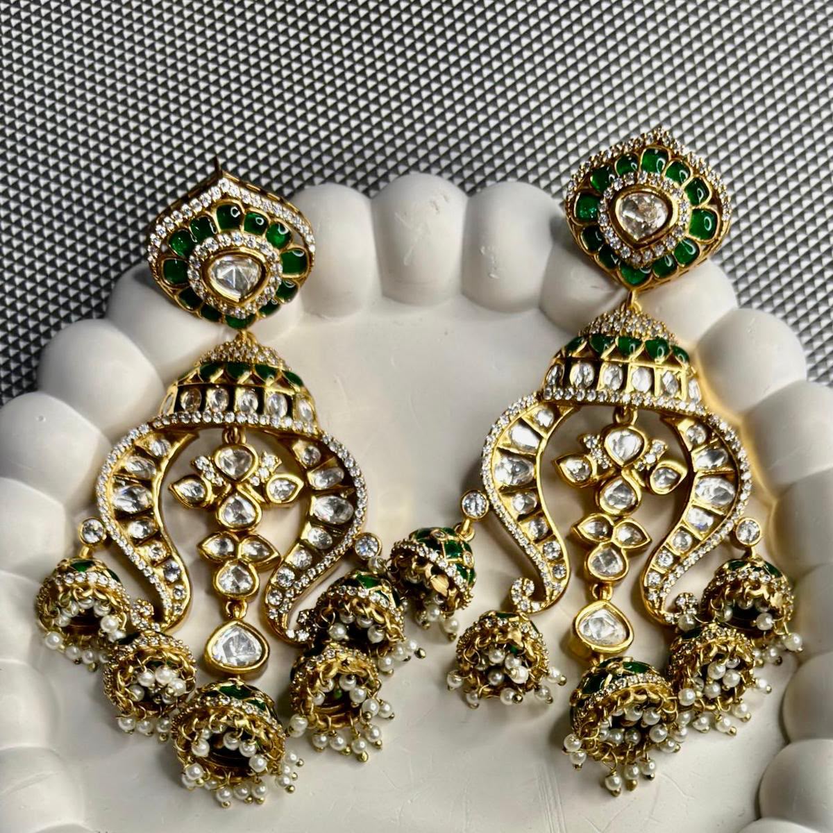 Close up of Emerald kundan multi jhumka earrings with epoxy work