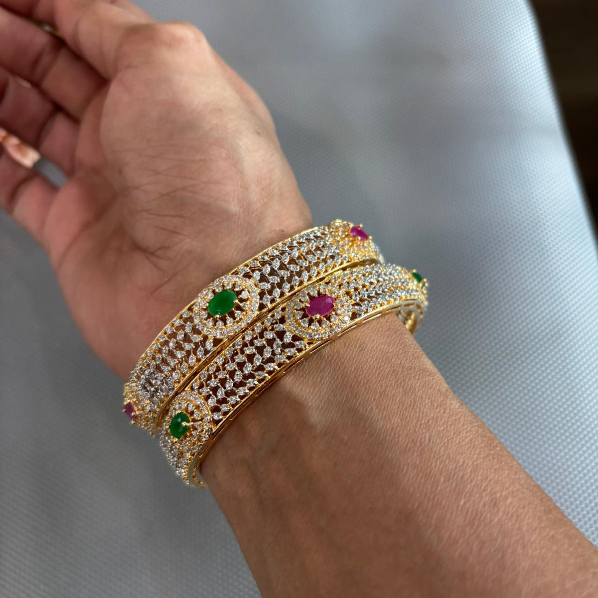 Pair of ruby emerald american diamonds gold tone Bangles