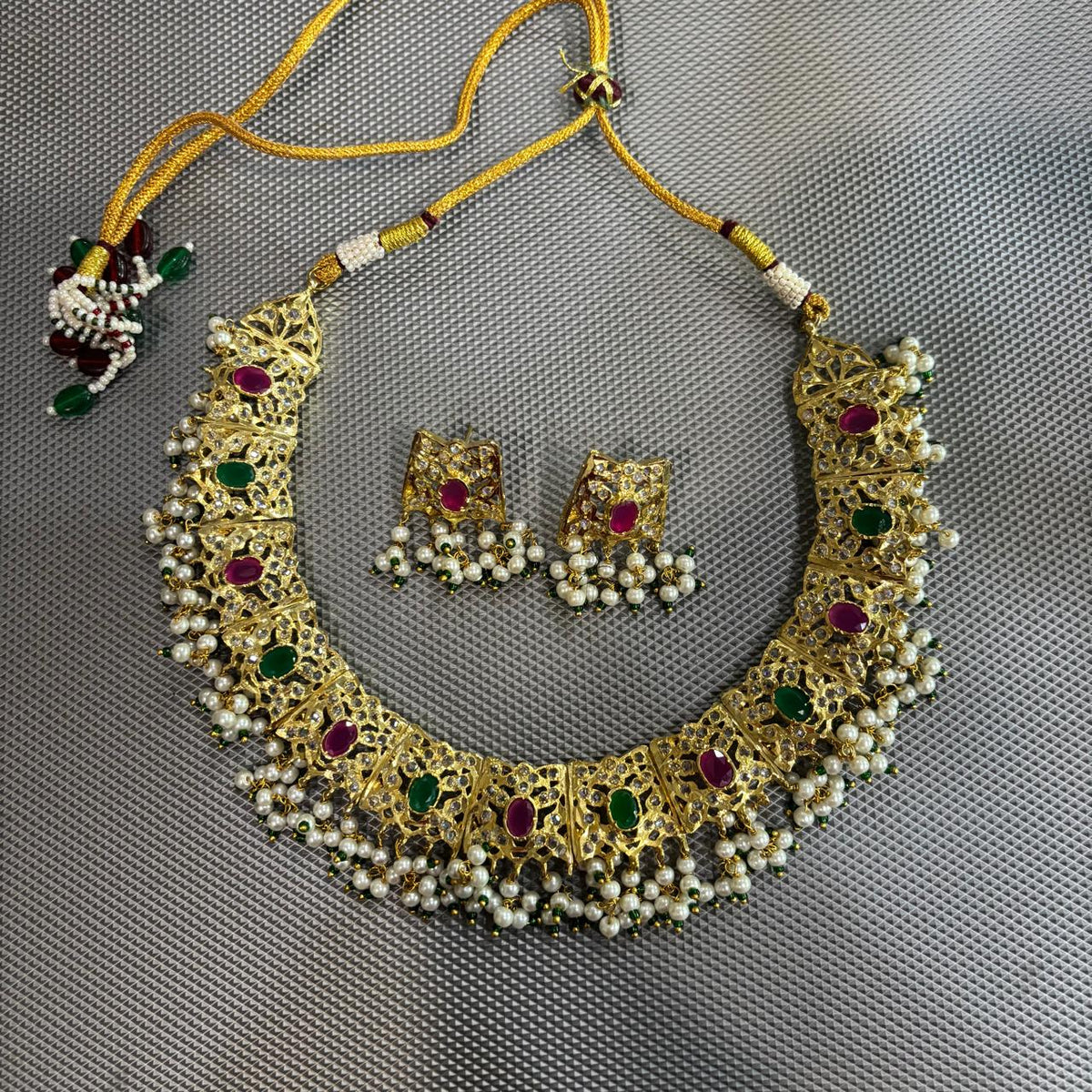 Jadau choker necklace set with emerald & ruby in gold plating and stud earrings