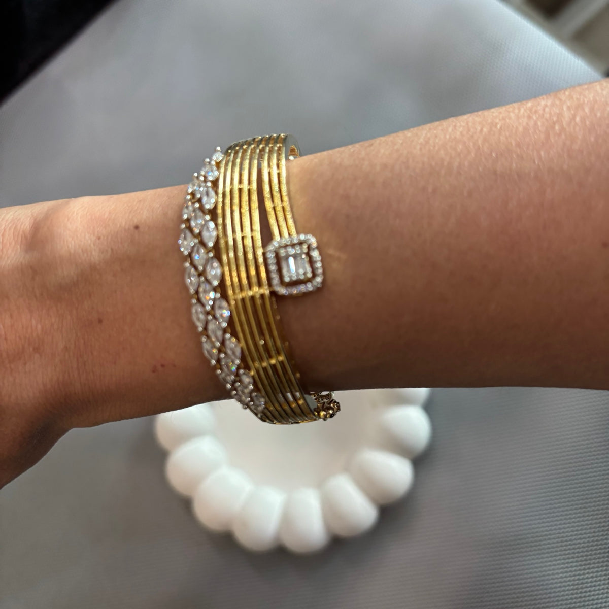Wrist close-up of Anshi bracelet showing marquise stones and rectangular CZ detail