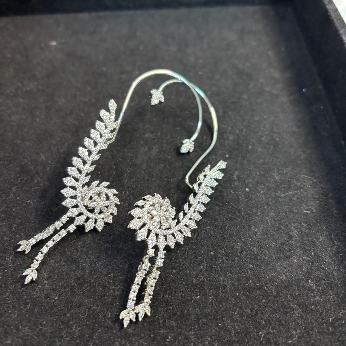 Silver plated ear cuff earrings with americn diamonds.