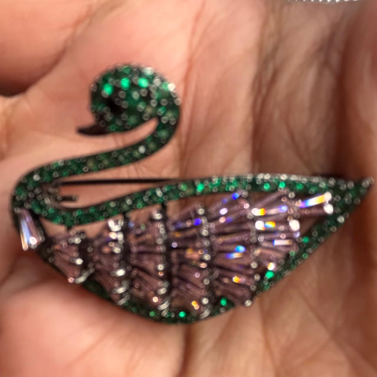 Green crystal swan brooch with lavender stone detailing