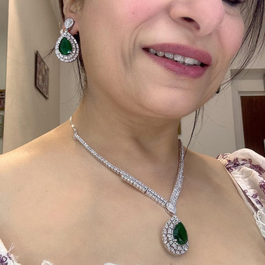 sophisticated american diamond necklace set with emerald stone pendant and matching earrings