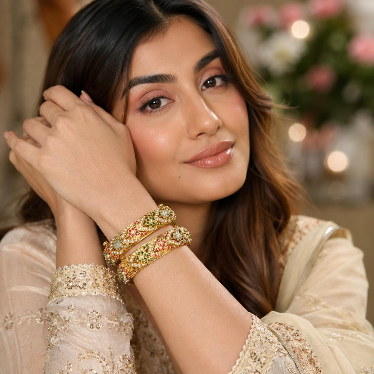 Woman wearing multicolour Navratna Jadau pearl statement bangles by Bebaak Jewels