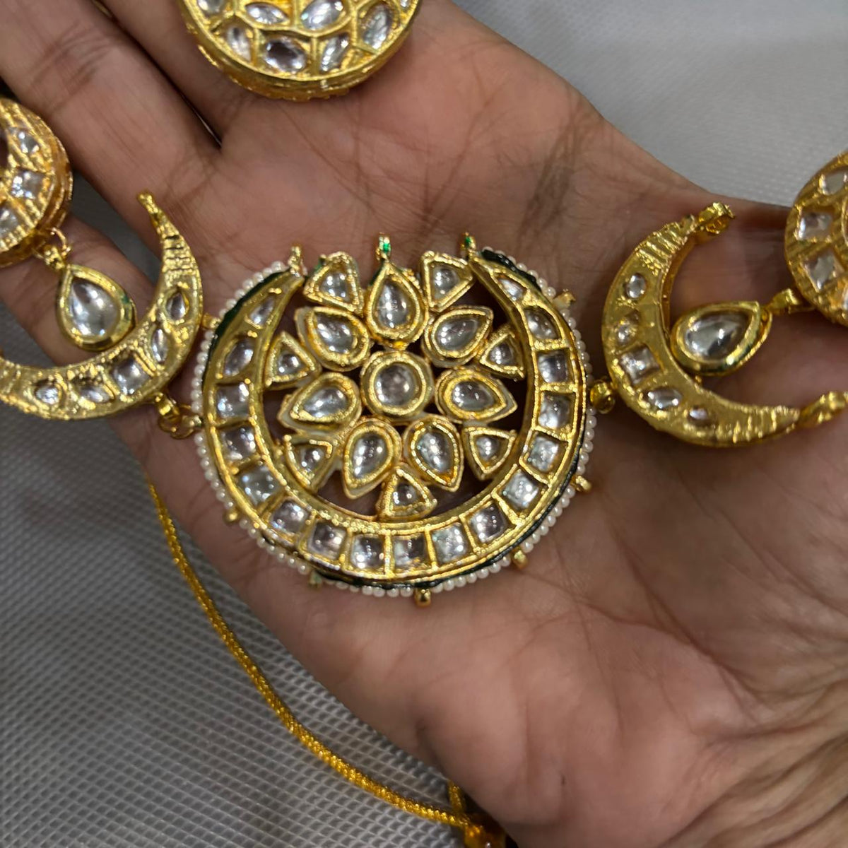 Close up crescent moon choker  necklace  set with white Kundan stones and pearl border in gold plating 