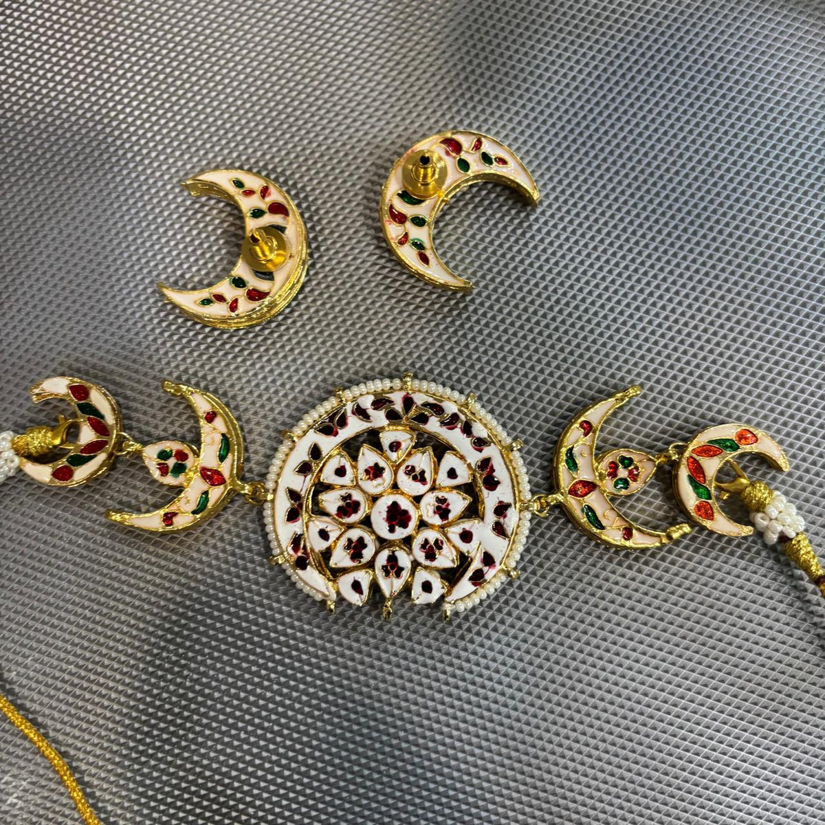 Back view of crescent Kundan necklace set with decorative enamel detailing