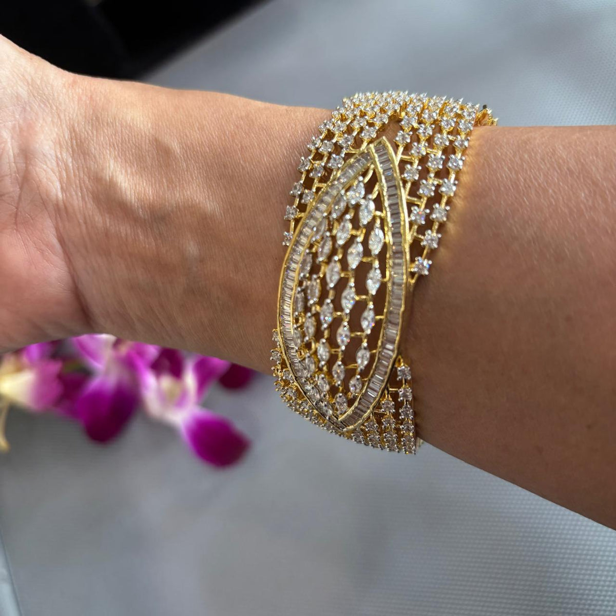 close up of American Diamond cuff bracelet with baguette and marquise stones on hand