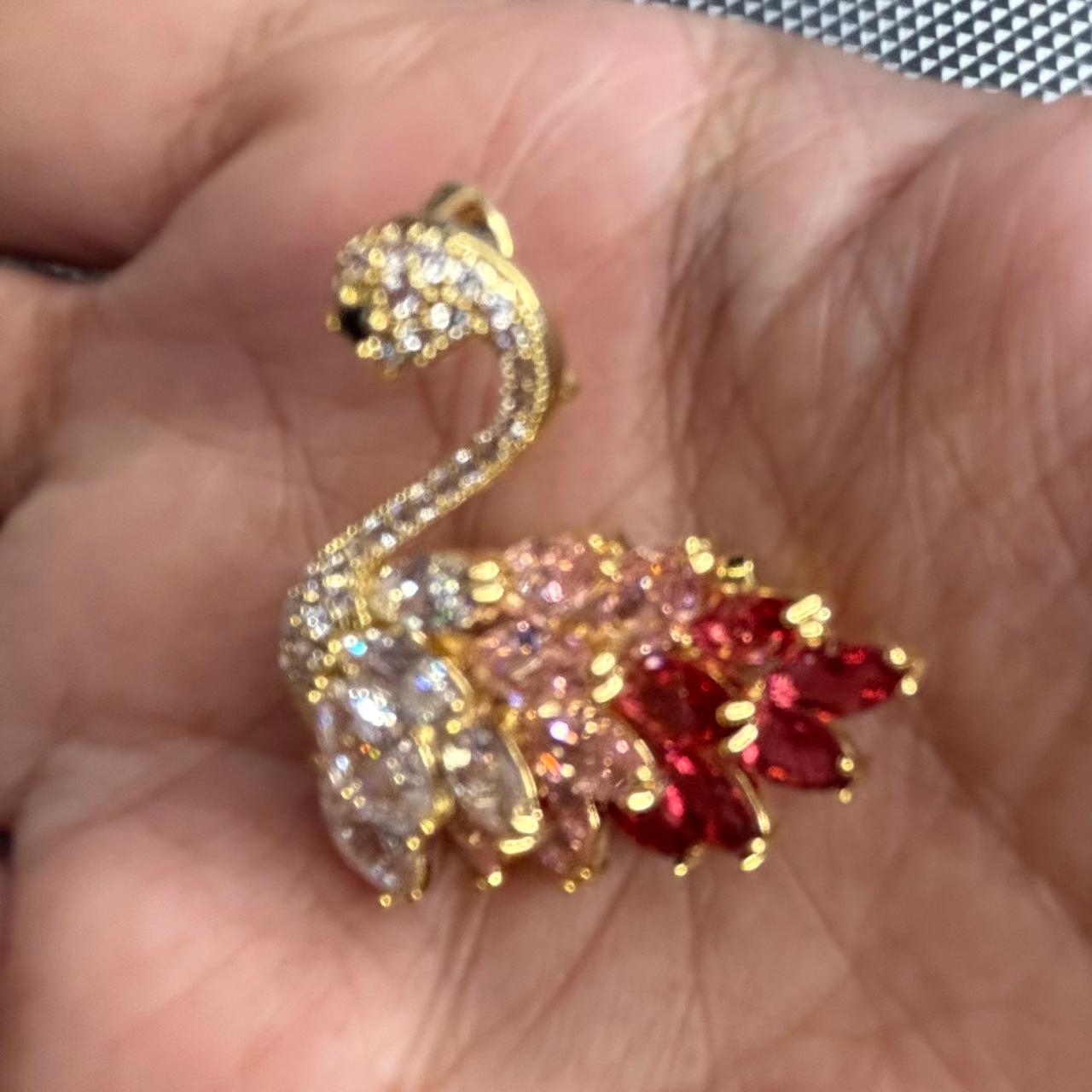 Pink and red crystals  with CZ diamonds  swan brooch shown in hand for size reference
