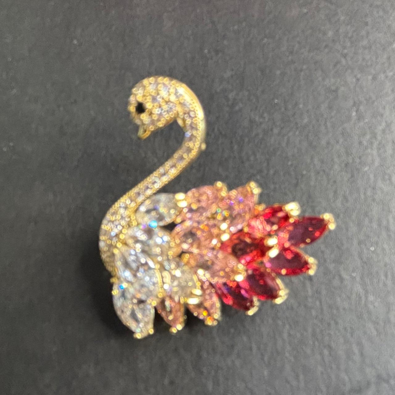 Gold tone swan brooch embellished with pink red and clear crystals and CZ diamonds.