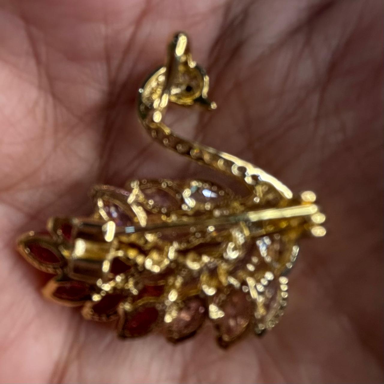 Back view of pink and red crystals swan statement brooch pin