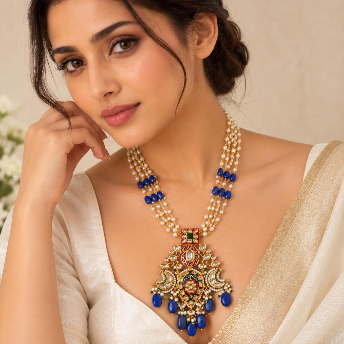 Woman wearing Lapis Lazuli drops Kundan necklace with red enamel and pearls on a saree