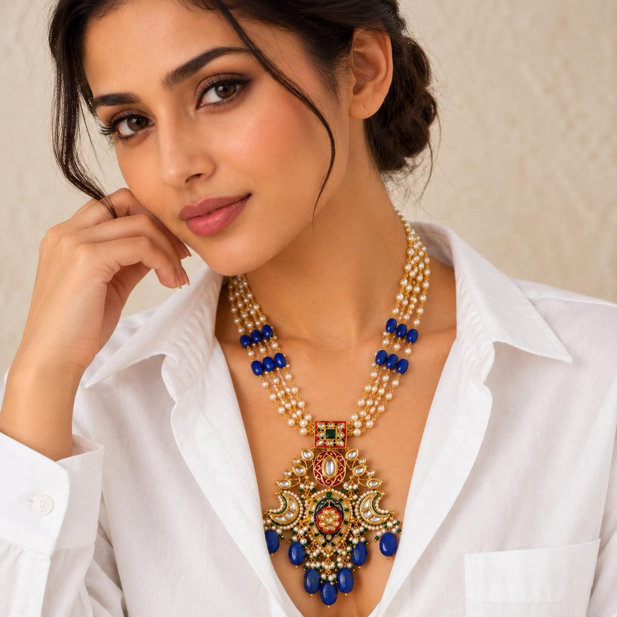 Woman wearing Lapis blue stone drops Kundan necklace with red enamel and pearls