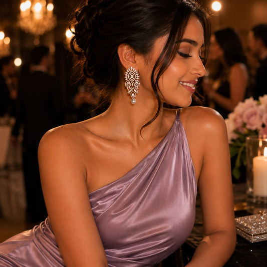 Woman wearing marquise American Diamond statement drop earrings with pear-shaped dangling stone in rhodium finish