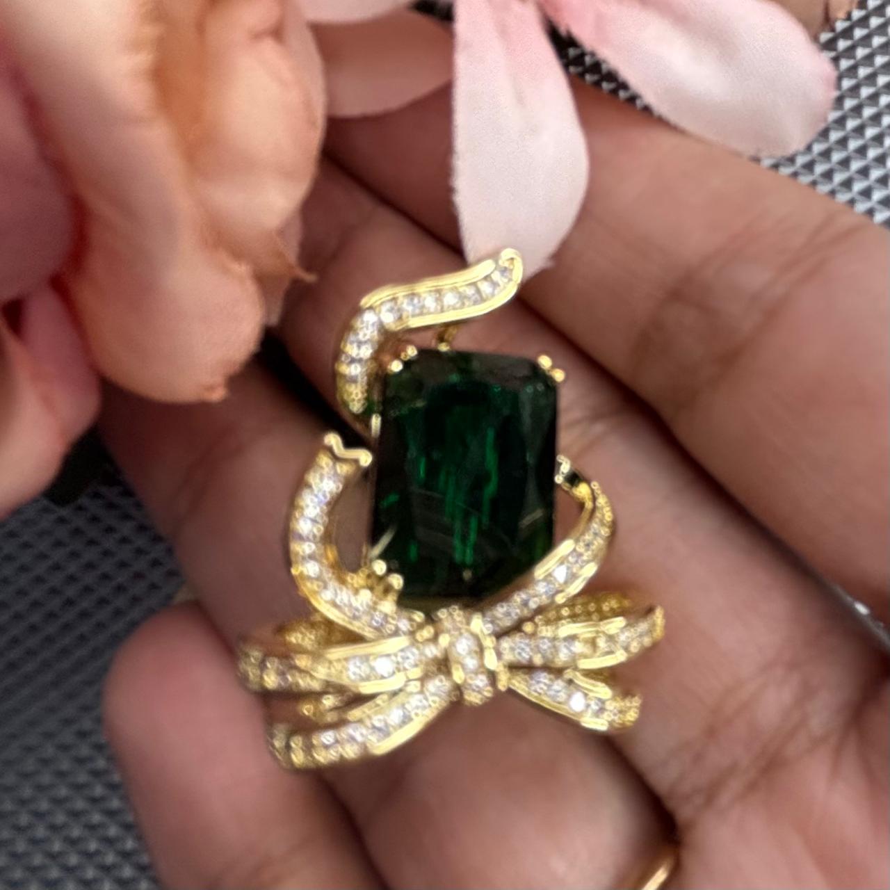 Emerald green crystal bow brooch pin with gold finish and sparkling cubic zirconia stones for sarees blazers coats dresses by Bebaak Jewels
