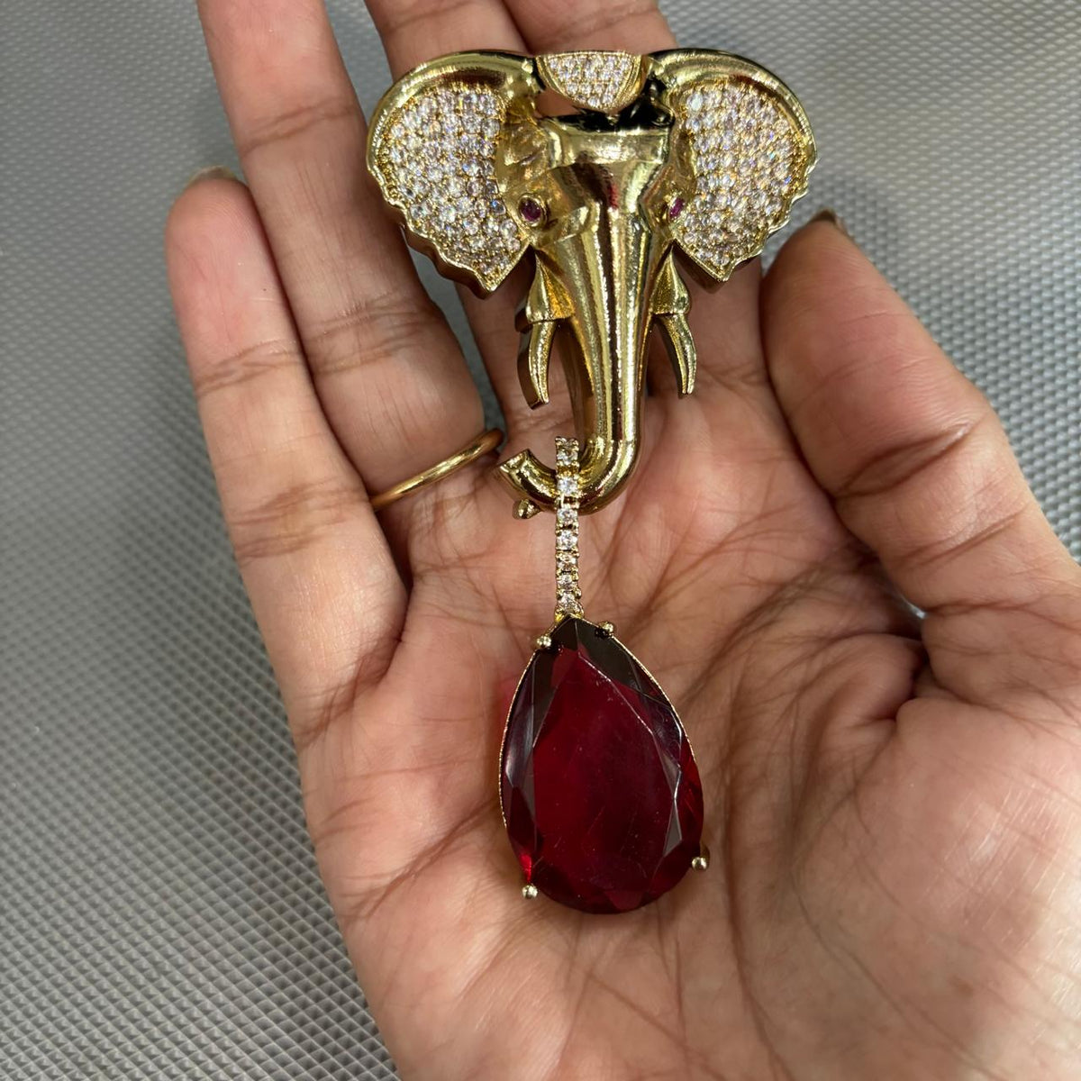 Handheld Gajanan elephant statement brooch with sparkling clear stones and ruby red drop