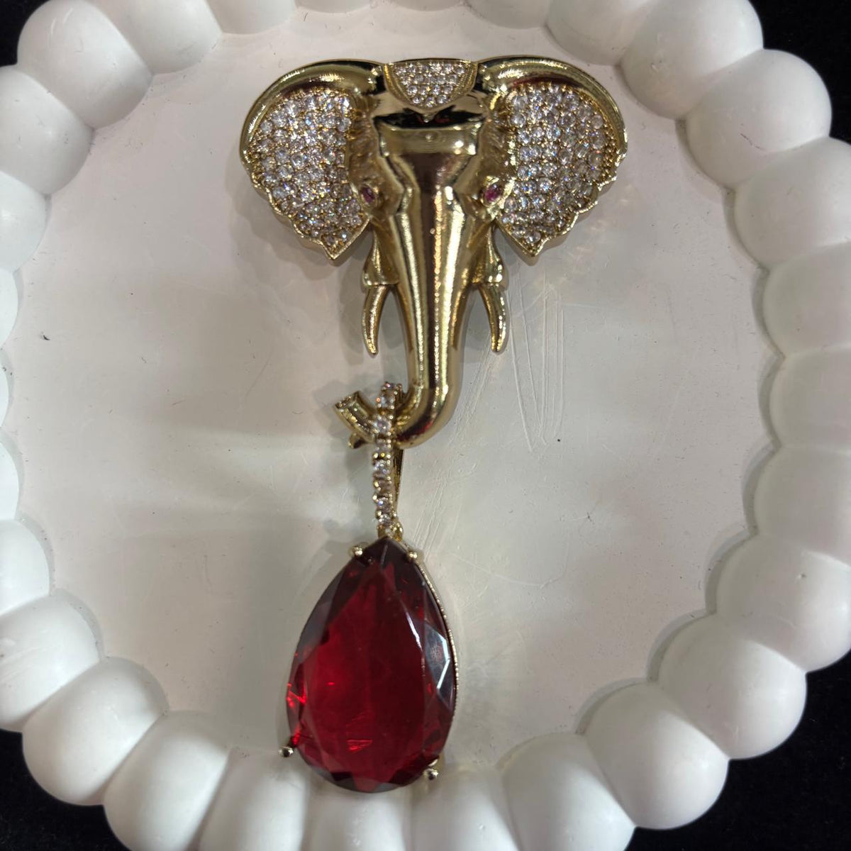 Gajanan elephant statement brooch with sparkling clear stones and ruby red drop
