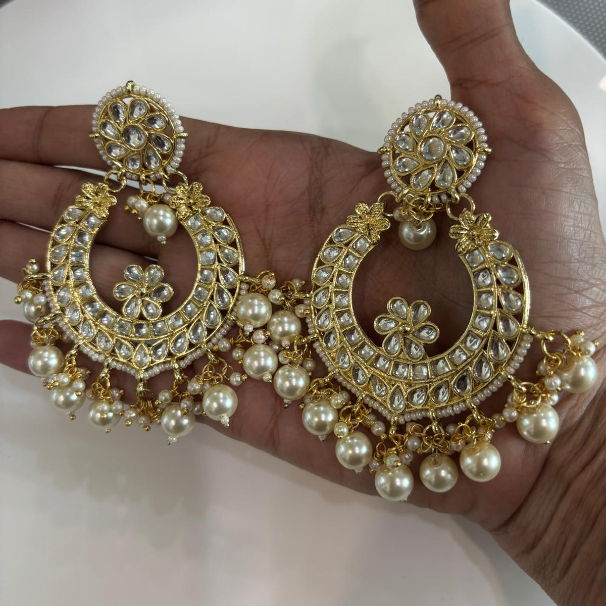 Handheld Oversized Indian chandbali earrings with Kundan-style stones and pearls
