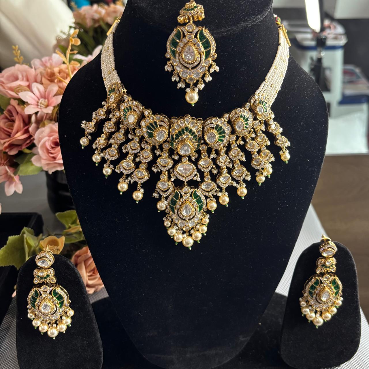 Luxury Emerald Green Kundan Bridal Necklace Set with Matching Earrings and Maang Tikka by Bebaak Jewels.