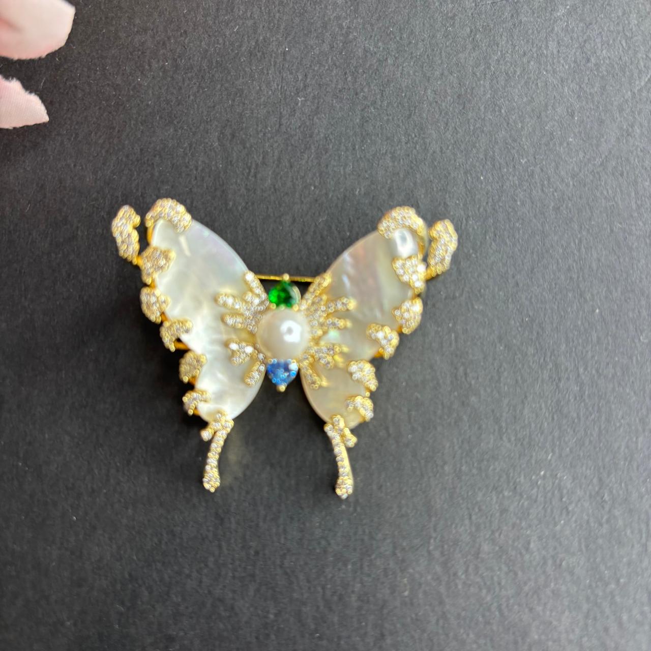 Luxury Mother of Pearl Butterfly Brooch with CZ diamonds detailing, pearl center and gold finish for sarees, blazers, dresses and scarves.