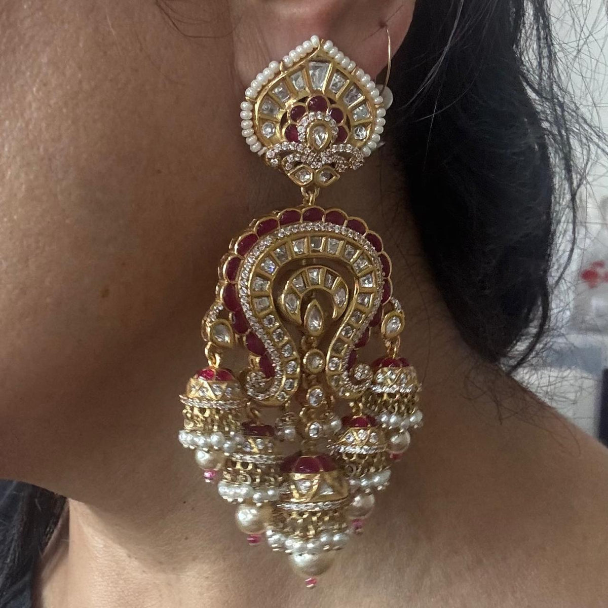 Maharani Kundan jhumka earrings worn on ear showing long statement size