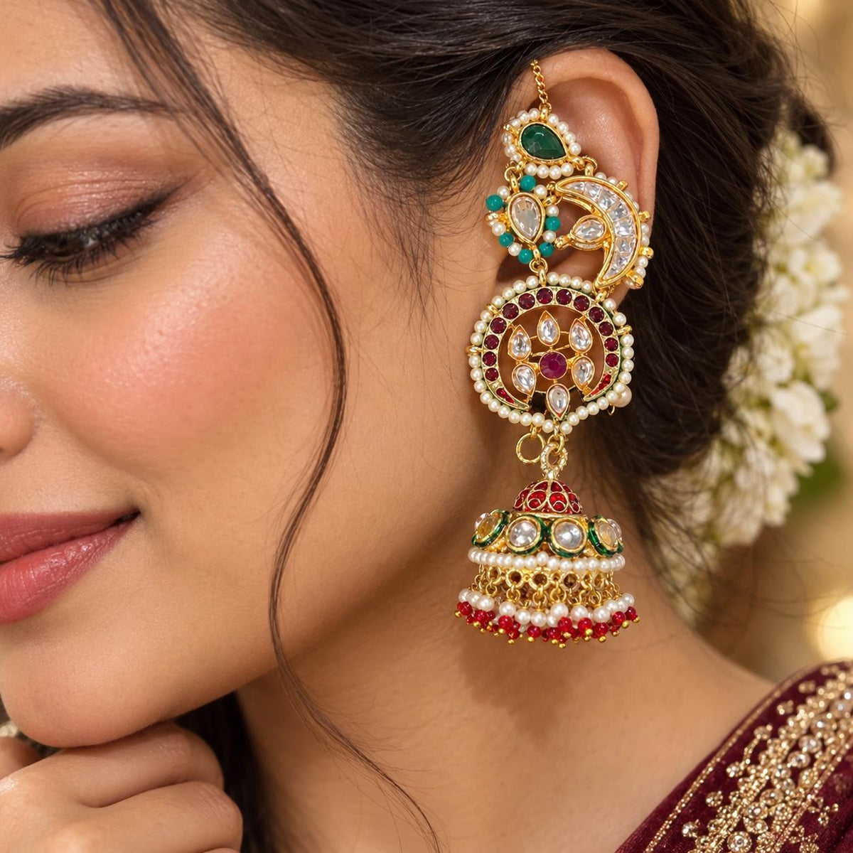 Women wearing earcuff jhumka earrings with firoza kundan and pearls