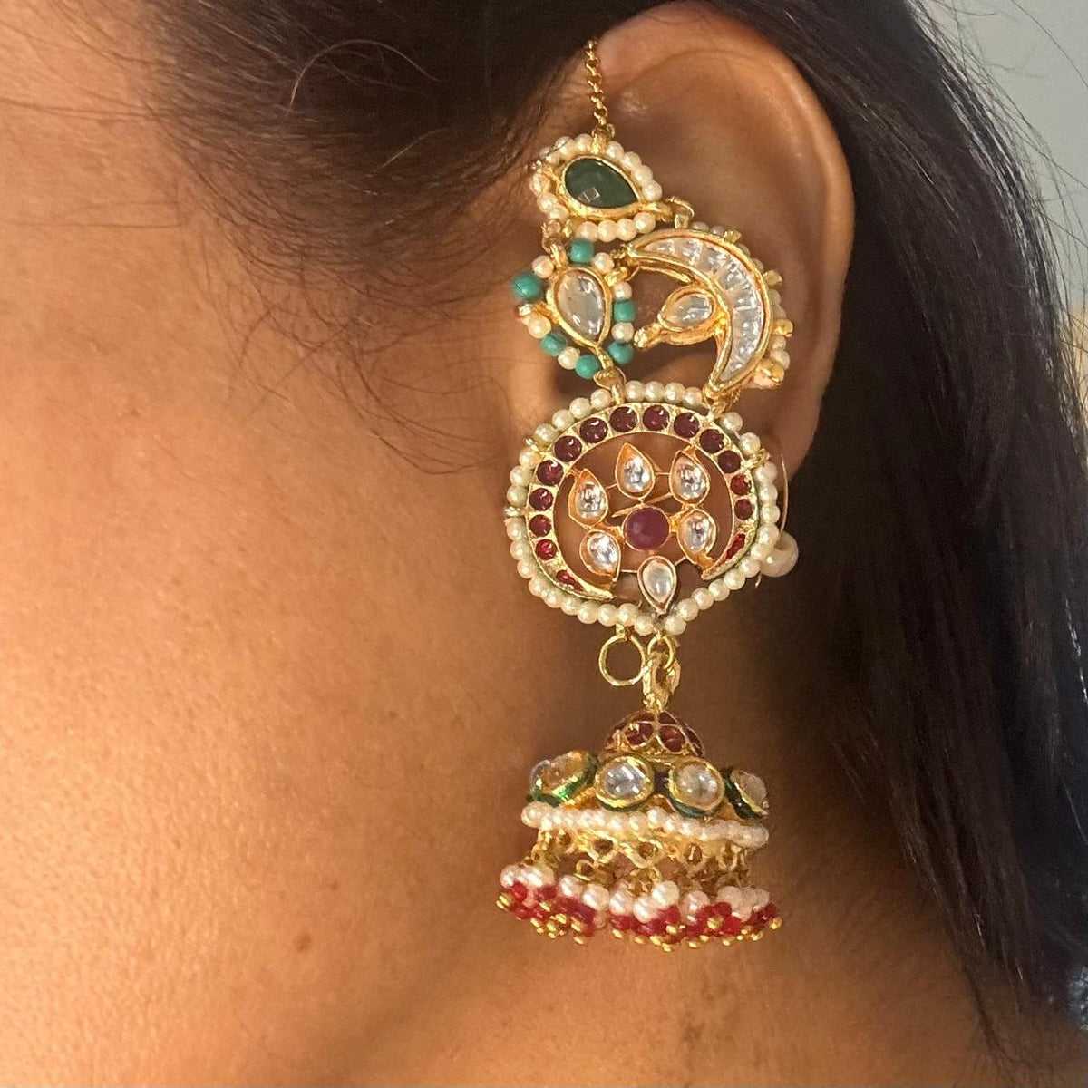 Close up of Women wearing earcuff jhumka earrings with firoza kundan and pearls
