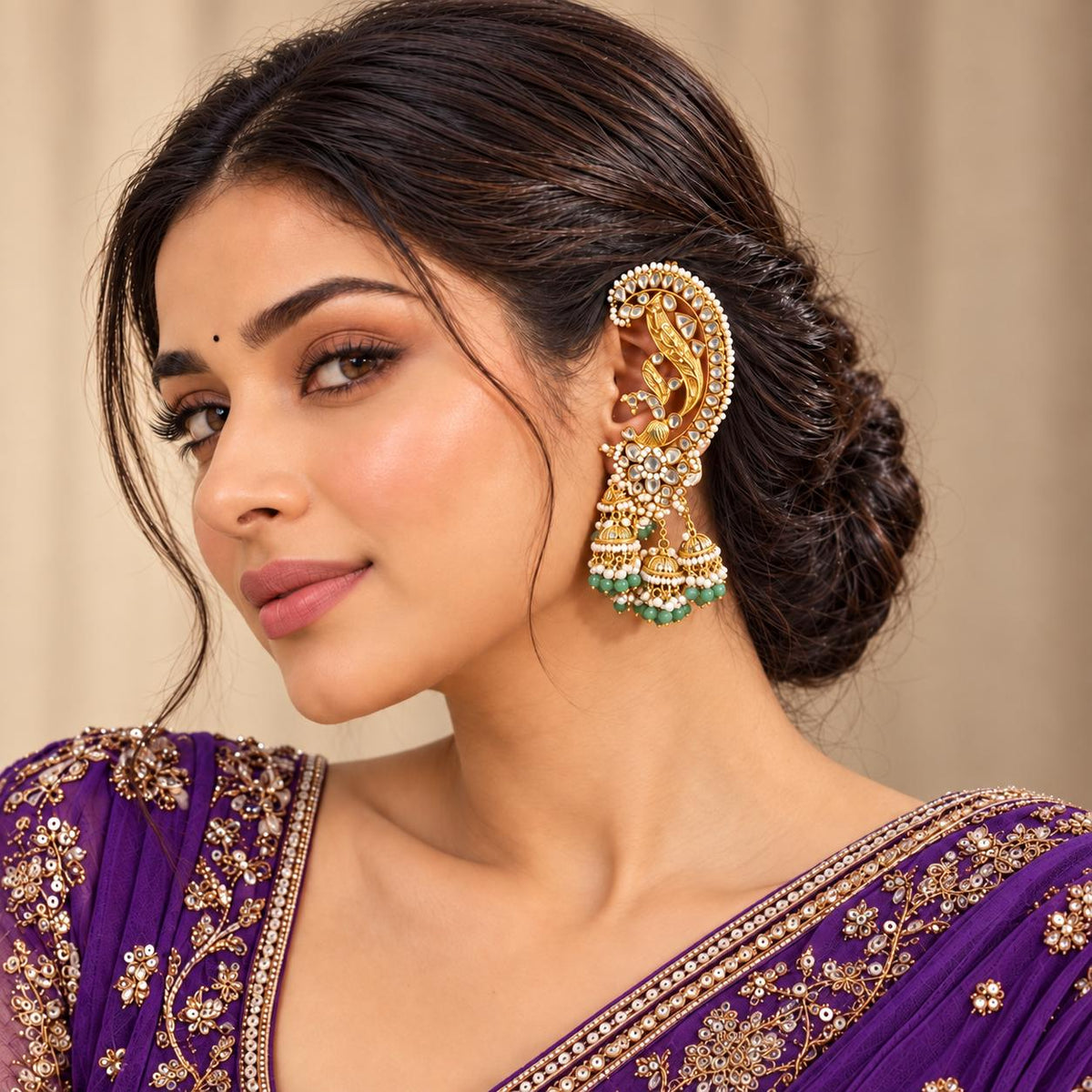 Woman wearing Woman wearing Light green Jadau Kundan peacock ear cuff earrings with dangling jhumkas