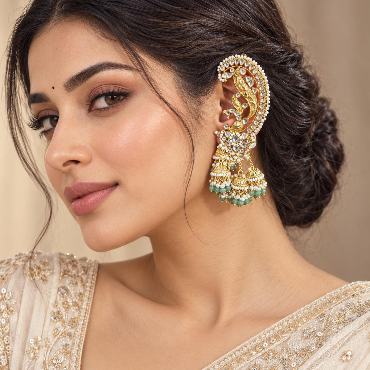 Woman wearing Light green Jadau Kundan peacock ear cuff earrings with dangling jhumkas