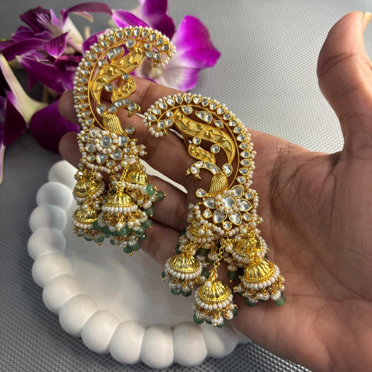 Jadau Kundan ear climber earrings with pearl and green bead details