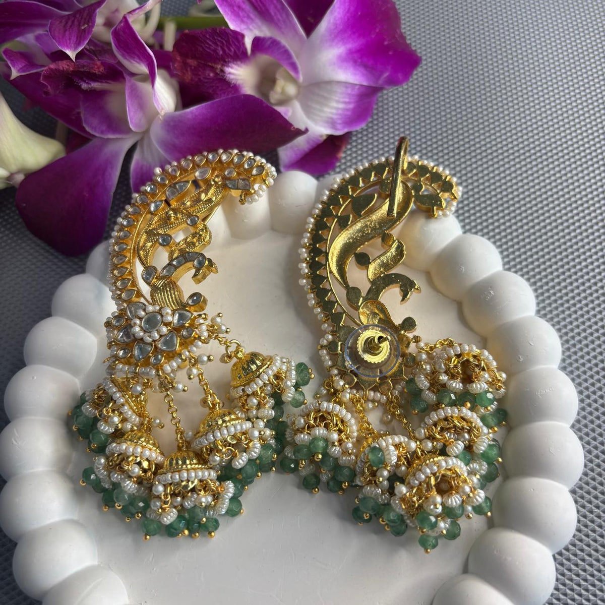 Back view of  Light green Jadau Kundan peacock ear cuff earrings with dangling jhumkas with pearls