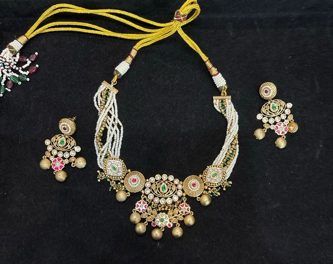 Model wearing Rajwada Pearl Kundan Choker Set with pearl strands and matching Kundan earrings by Bebaak Jewel