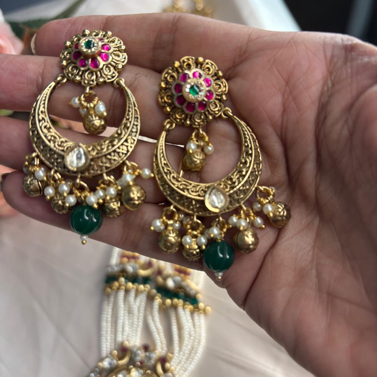 Rajwadi Kundan pearl  long necklace set with antique gold finish, multi-layer pearl strands, ruby accents, emerald green bead drops and matching chandbali earrings.