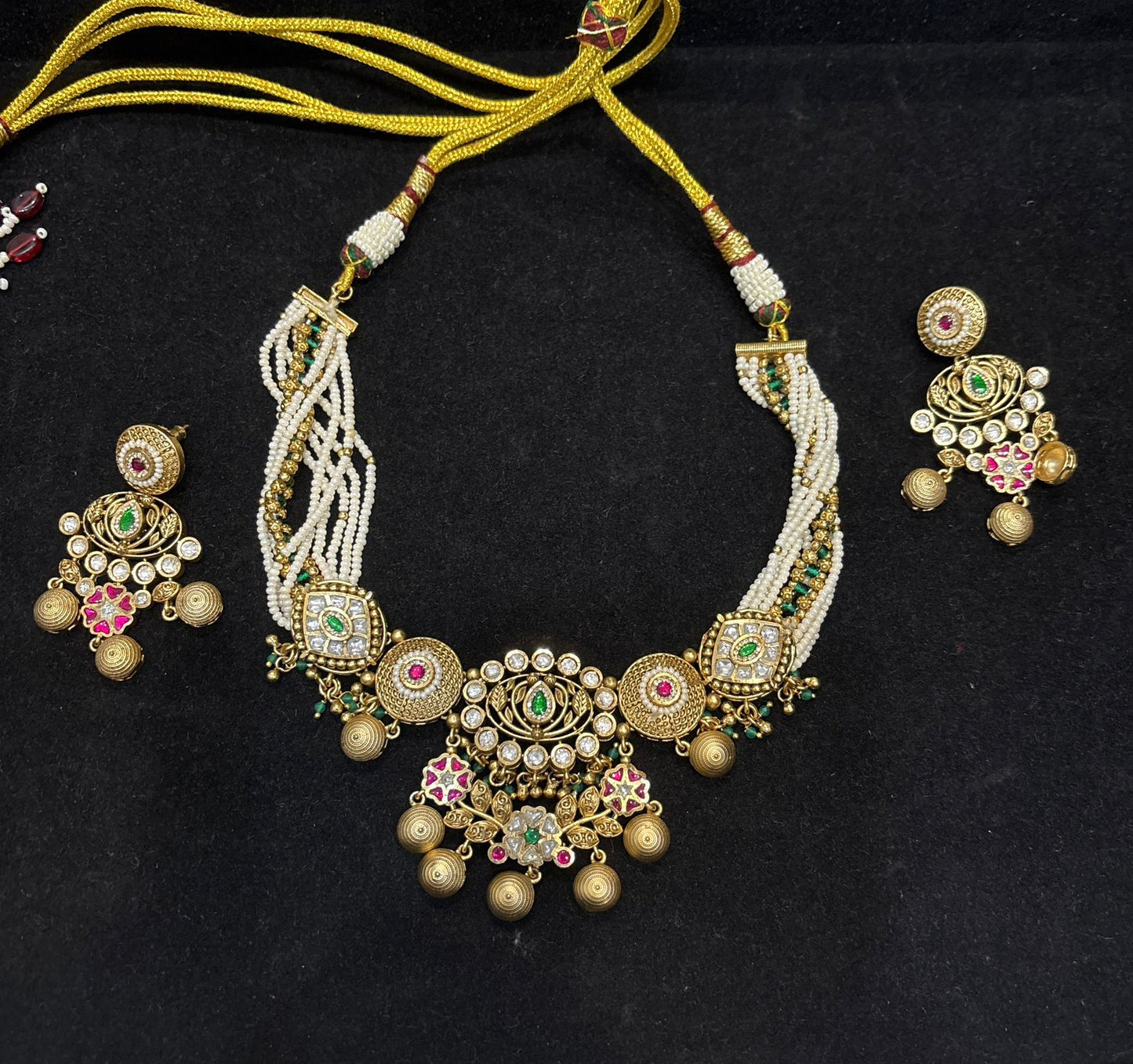 Model wearing Rajwada Pearl Kundan Choker Set with pearl strands and matching Kundan earrings by Bebaak Jewel