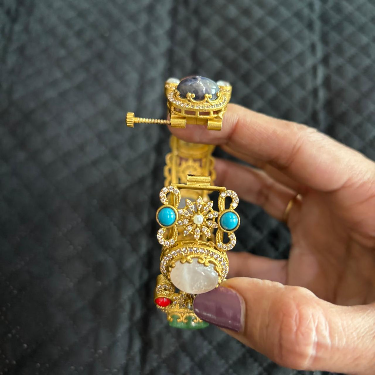 Openable multistone kada with oval cabochon style stones and floral crystal design