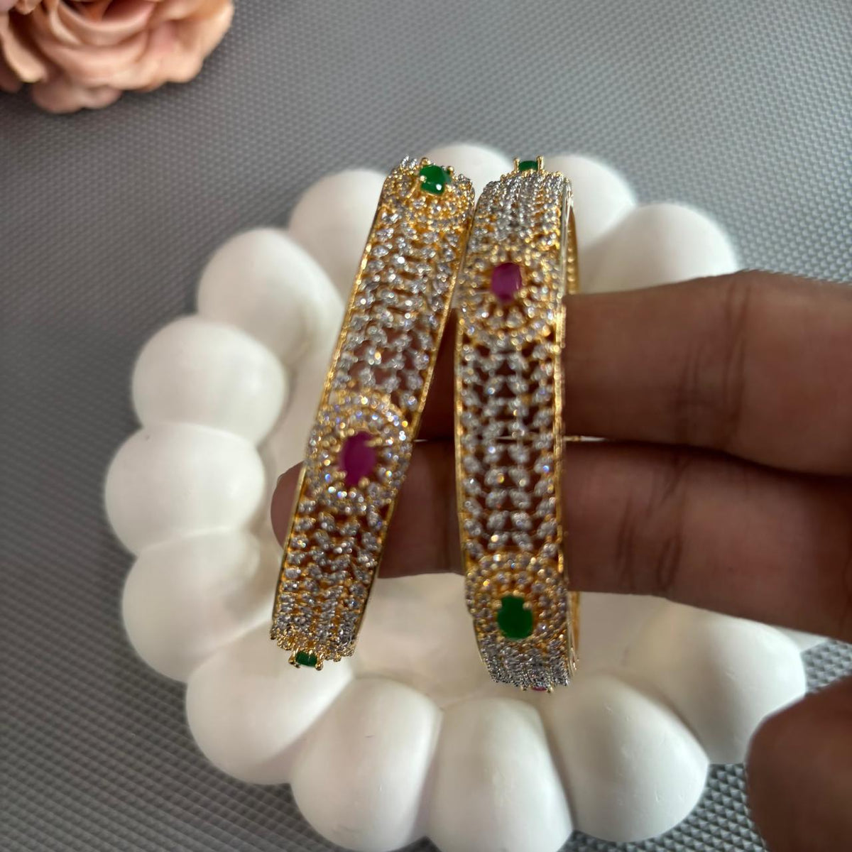 Ruby and emerald AD statement bangles with intricate clear stonew