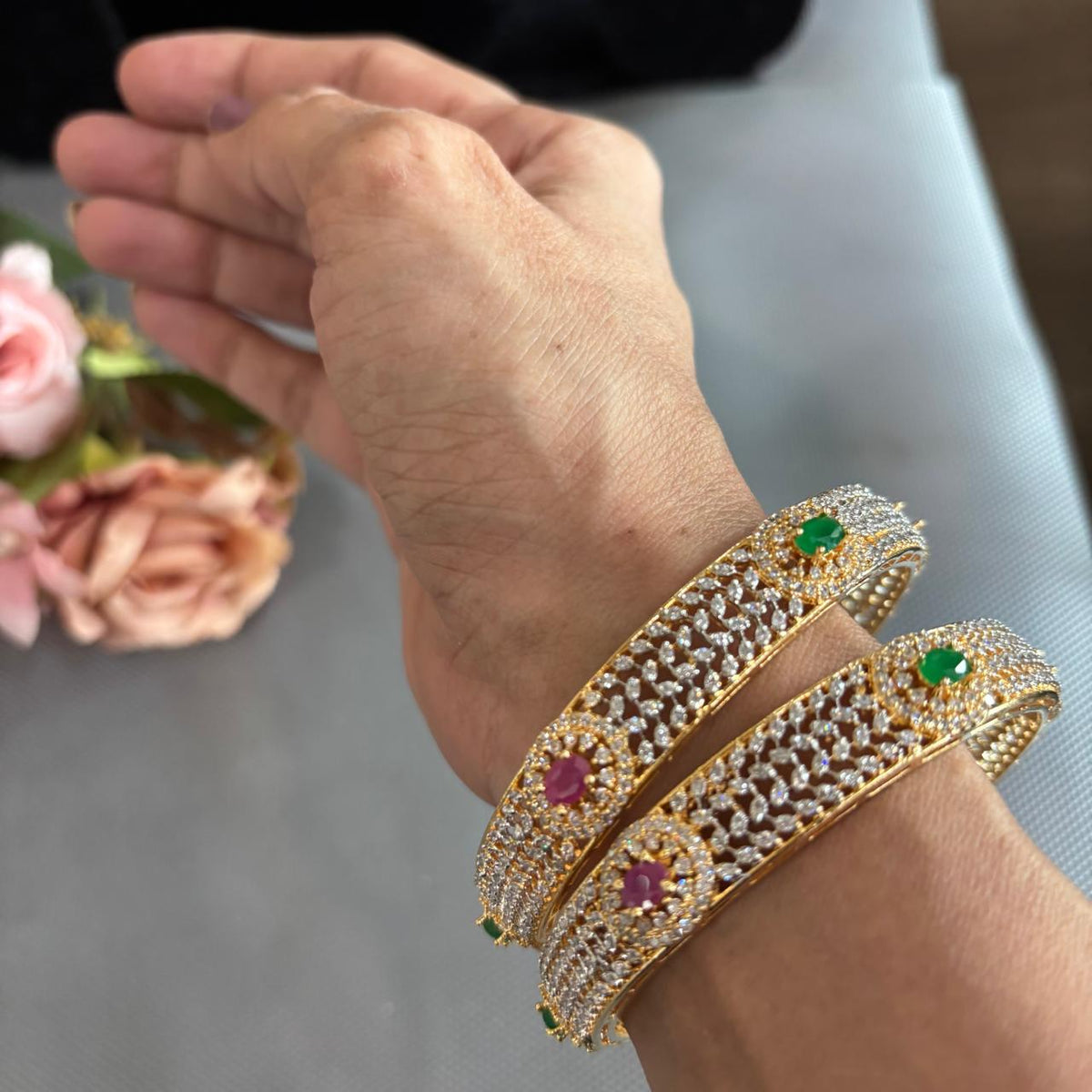 Pair of  ruby emerald american diamonds gold tone Bangles on hand
