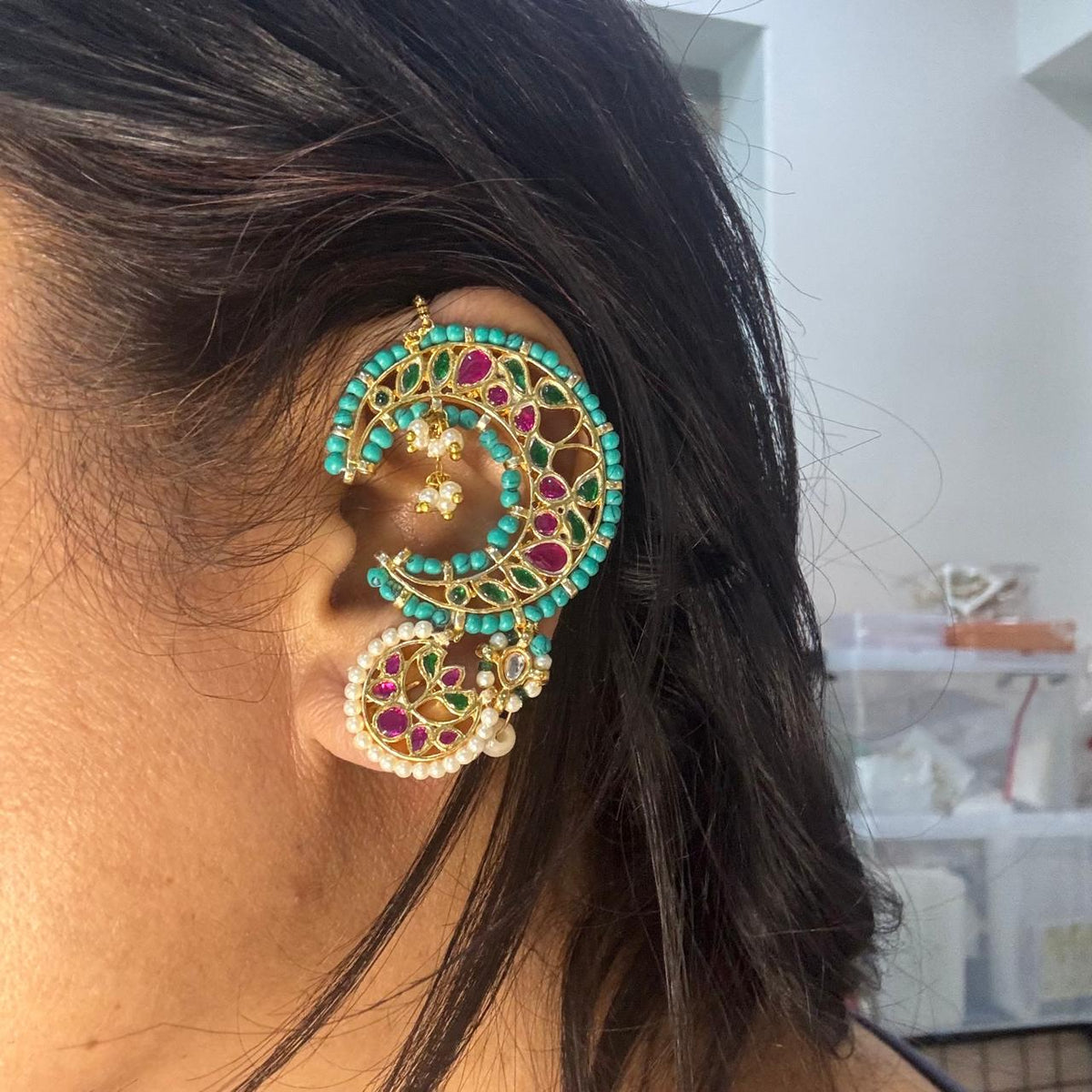 Women wearing Traditional turquoise Kundan kaanphool statement earring with pearls styled for wedding wear