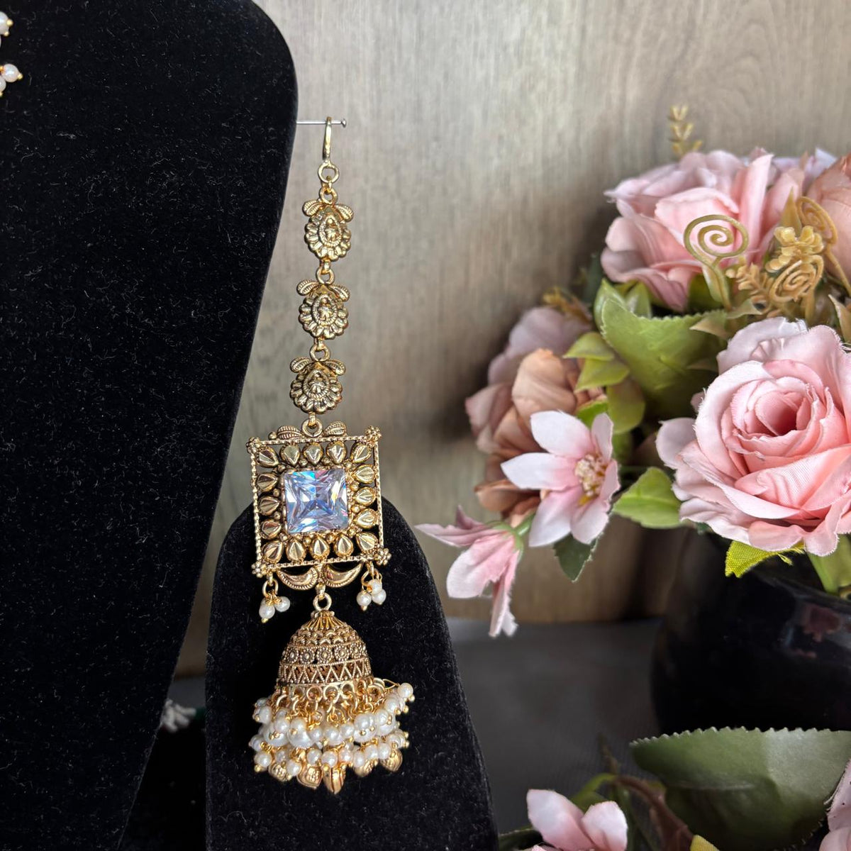 Close up view of  Antique gold bridal  kannauti jhumka earrings with white pearls