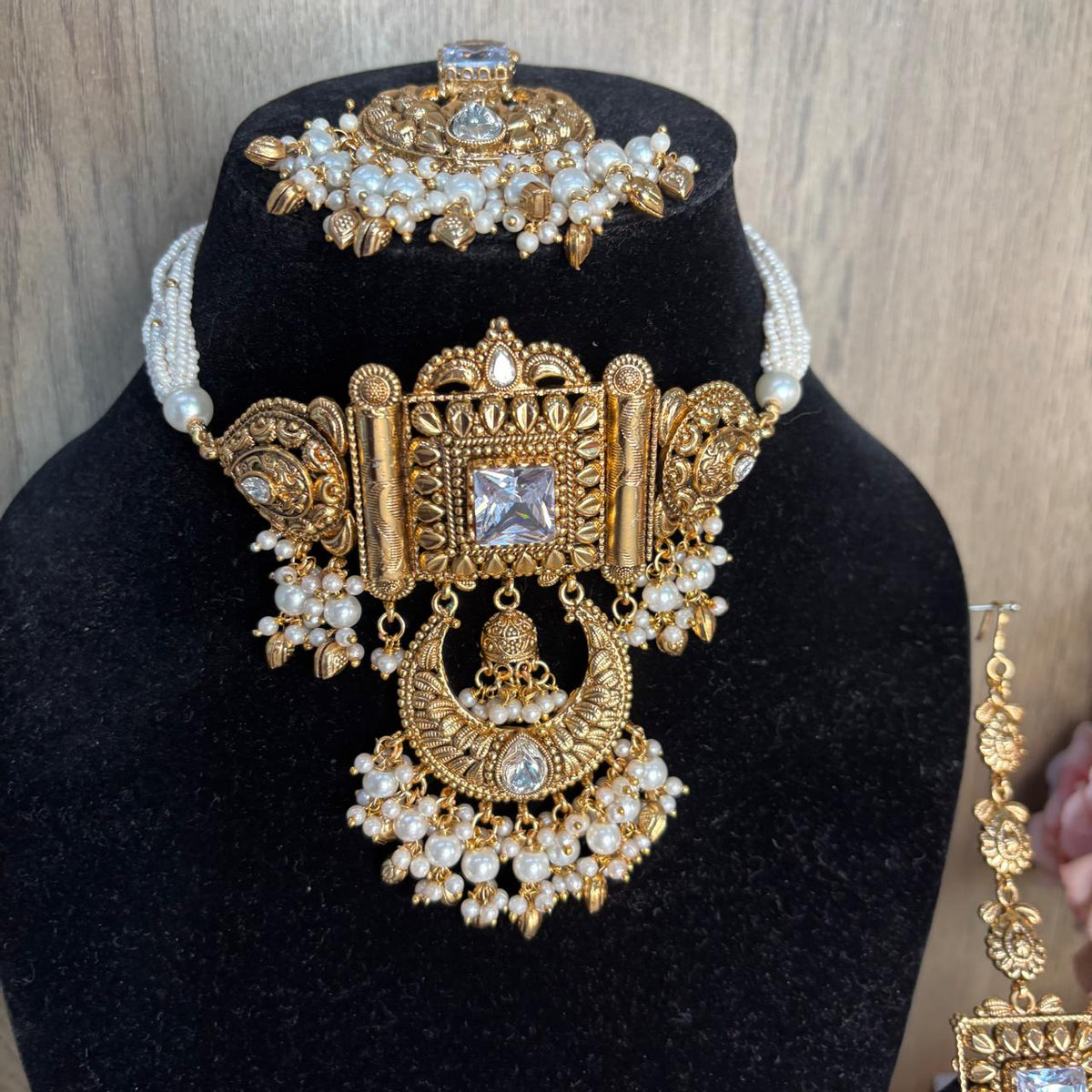 Close up view of  Antique gold bridal choker necklace set with white pearl strands 