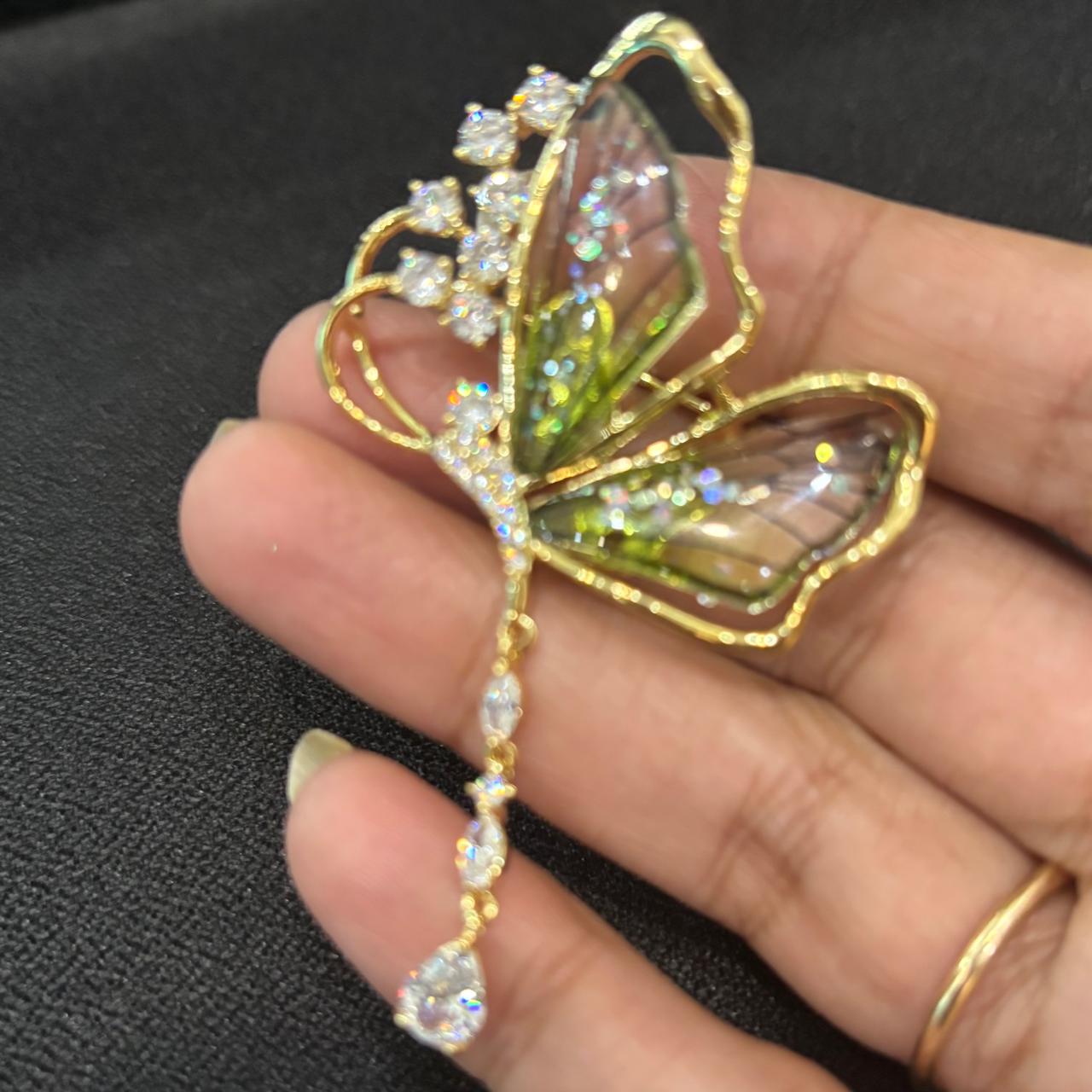 Soft green butterfly brooch with sparkling diamond-look cubic zirconia stones and elegant crystal drop.