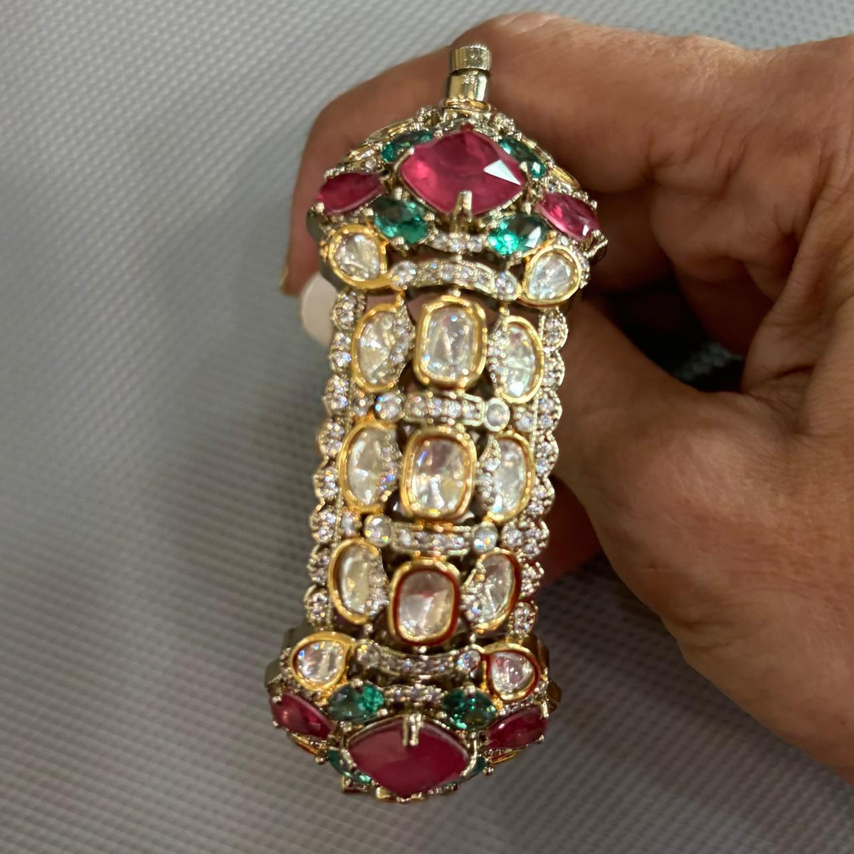 Close up of Polki moissanite style openable kada with pink and green stones